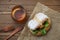 fried chicken hamburger lettuce on brown paper isolated on wooden table