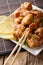 Fried chicken karaage with a lemon close-up. vertical, japanese
