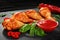 Fried chicken legs with ketchup, chili pepper and basil