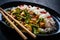 Fried chicken nuggets in curry sauce with white rice, green beans, parsley and chili peppers on black wooden table