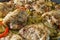 Fried chicken with potato chips closeup. Spices added.