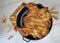 Fried chicken. On the table in a cast-iron pan, with a crisp, Golden crust. Bread sticks with sesame seeds. Wooden background