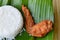 Fried chicken wing eat couple with rice on fresh banana leaf