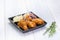 Fried chicken wing and salad on tablecloth on white wood table in kitchen,food menu appetizer