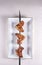fried chicken wings on a skewer and a white plate. BBQ Chinese cuisine
