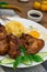 Fried chicken wings with spaghetti. Wooden background. Close-up. Top view