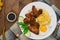 Fried chicken wings with spaghetti. Wooden background. Close-up. Top view