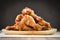 Fried chicken wings on wooden plate - Baked chicken wings BBQ on black background