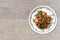 Fried crispy barbecue pork with basil leaves and chilly over white steamed rice thai food on wood background.