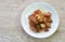 fried crispy chicken with cashew nut and slice onion on plate