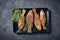 Fried crispy crucian carps on a rectangular plate