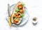 Fried crispy tempura shrimp, tomato and yogurt sauce sandwich on light background, top view