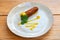 Fried croquette appetizer drizzled with mustard sauce, mediterranean appetizer. On a plate on a wooden background close