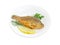 Fried crucian with lemon and potherb on white dish