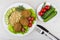 Fried cutlets with vegetables, brown rice in plate, fork, knife