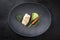 Fried Danish skrei cod fish filet with baby zucchini, carrot and lettuce on a modern design plate