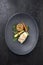Fried Danish skrei cod fish filet with vegetable, lettuce and mushroom rice on a modern design plate