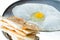 Fried delicious Roti with eggs on a hot pan, white background, focus selective
