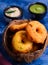 Fried donuts - vada and chutney in a coconut shell