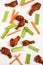Fried drumsticks, celery and carrot scattered on white plate