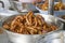 Fried duck feet in a silver container