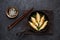 Fried dumplings Gyoza in a frying pan, soy sauce, and chopsticks