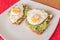 Fried egg on avacado guacamole and brown toast