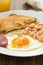 Fried egg with beans, smoked sausage and toasts