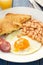 Fried egg with beans, smoked sausage and toasts