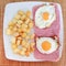 Fried egg with ham and roast potato cubes