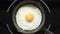 Fried egg on a pig-iron frying pan preparation process time lapse