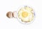 fried egg in a plate with broken egg skin isolated on white background on top view. Food cooking