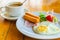 Fried egg with sausage and ham served with vegetable salad and hot coffee for appetizing breakfast