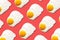 Fried egg or scrambled eggs pattern on coral background. Creative food concept. Top view. Conceptual trend. Banner. Keto diet.