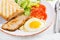 Fried egg with slice pork, tomatoes and toasts.