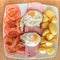 Fried egg and small roast potatoes with ham and tomatoes