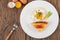 Fried egg on a white plate with toast, sliced â€‹â€‹Spring onion and sliced â€‹â€‹tomatoes