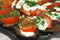 Fried eggplants and fresh tomato with souce and herbs