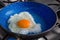 Fried eggs in a blue pan