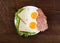 Fried eggs breakfast toast salad on wooden