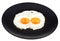 Fried eggs on ceramic black plate