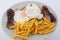 Fried eggs with french fried potatoes and bacon