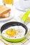 Fried eggs in a frying pan, crisp toast, coffee and orange juice