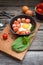 Fried eggs in a frying pan with sausages, cherry tomatoes, herbs, spices and bread for breakfast