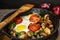 Fried eggs with mushrooms, tomatoes and herbs