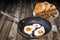 Fried Eggs In Old Teflon Frying Pan With Plateful Of Baguette Slices And Pitta Bread Loafs Set On Old Cracked Garden Table