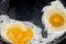 Fried eggs in a pan. Fried two eggs. cook an omelet in a pan three yolks. Fried eggs for breakfast close-up.