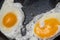 Fried eggs in a pan. Fried two eggs. cook an omelet in a pan three yolks. Fried eggs for breakfast close-up.