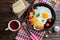 Fried eggs in pan with tomato, bread, pepper and parsley