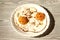 Fried eggs on a plate with chili peper